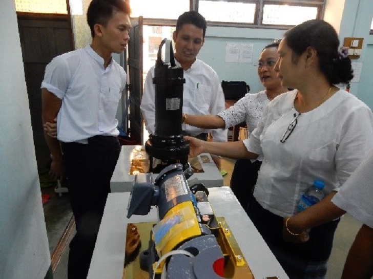 Students surround a donated Ebara cut model.