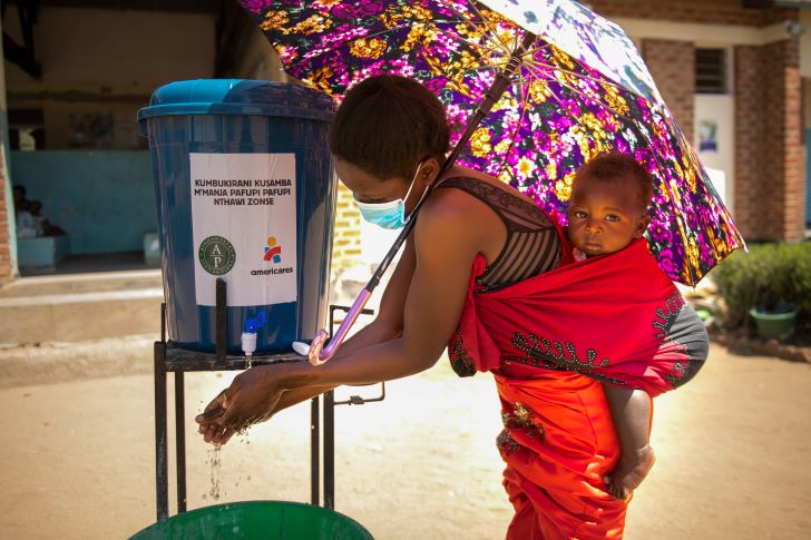 A woman washes her hands upon arrival at Namanolo Health Centre in Balaka Southern Malawi in November 2020. Photo: Thoko Chikondi.