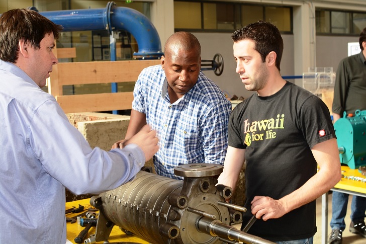 Students receiving practical experience and expert help at the ‘Pump Assembly’ module.