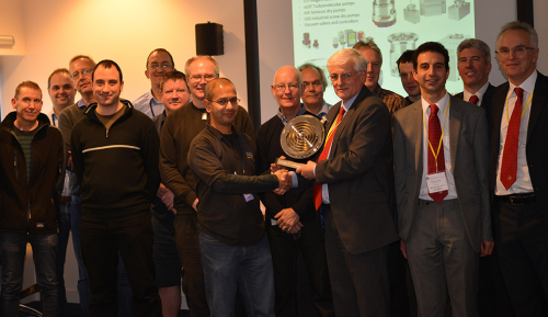 Neil Lavender Jones, vice president High Vacuum, Edwards, centre right, presenting an award to Sunil Patel, Vacuum Leader at ISIS, STFC, centre left, with other employees from STFC, CCFE and Edwards.