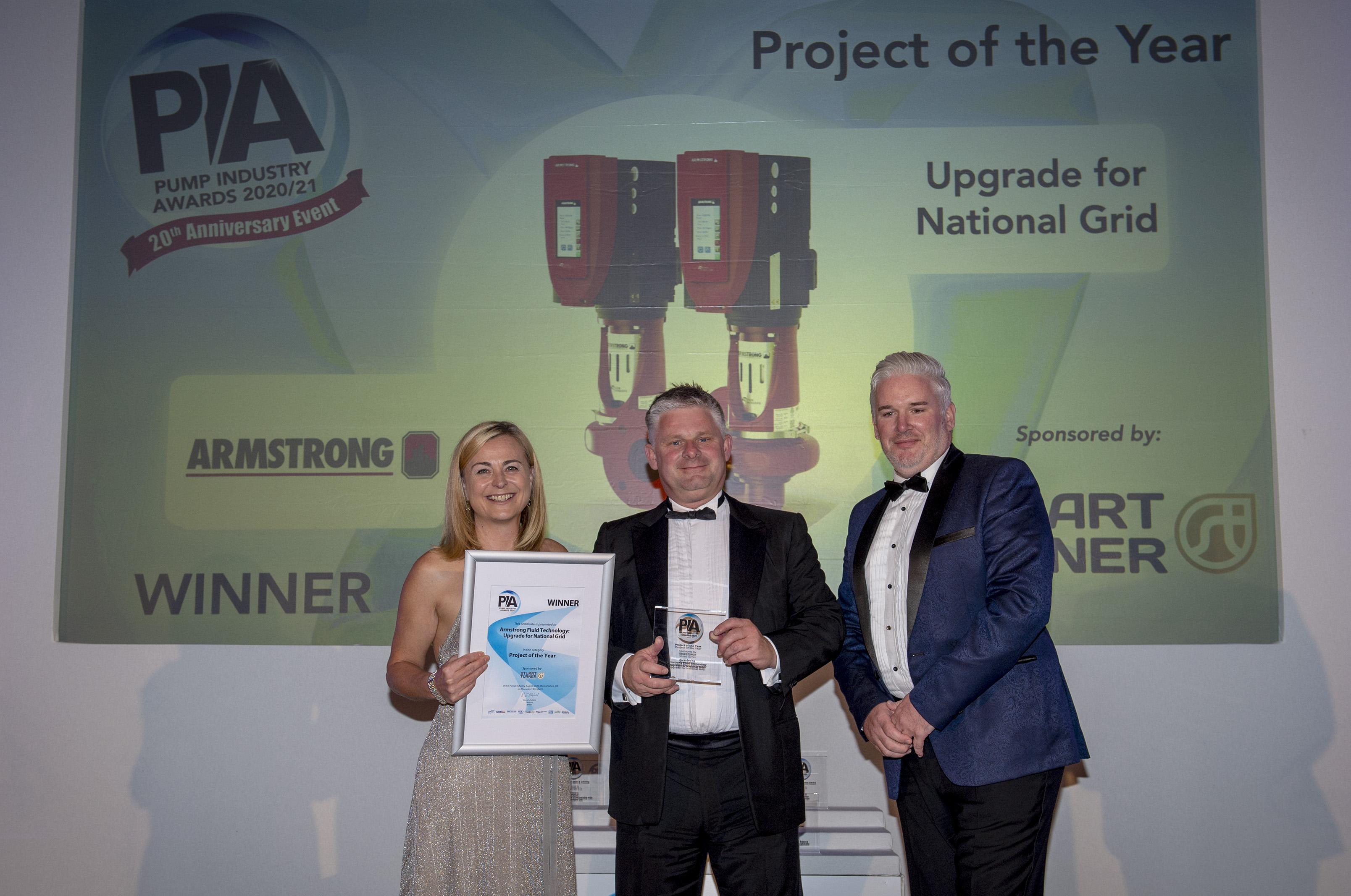 Philippa Forrester (left) presenting the award to Stephen Hart, sales director - UK, Armstrong Fluid Technology with sponsor's (Stuart Turner) global sales director, Kevin Moore (right).
